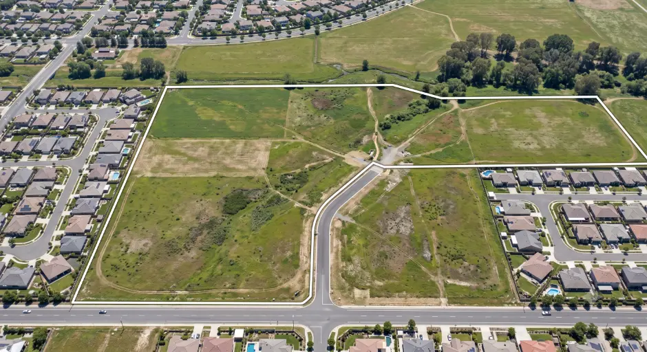 Drone view of vacant land near residential area- Can I sell my land to the bank?-3