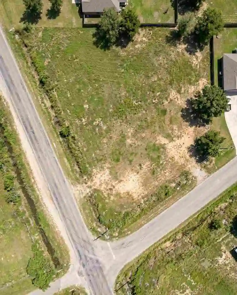 Straight-down aerial drone photograph of a vacant rectangular land parcel with road access in Harris County Texas - Sell My Land Harris County -  2